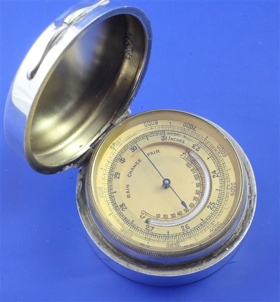 An Edwardian silver circular cased brass barometer retailed by Percy Edwards & Co, 2.25in.
